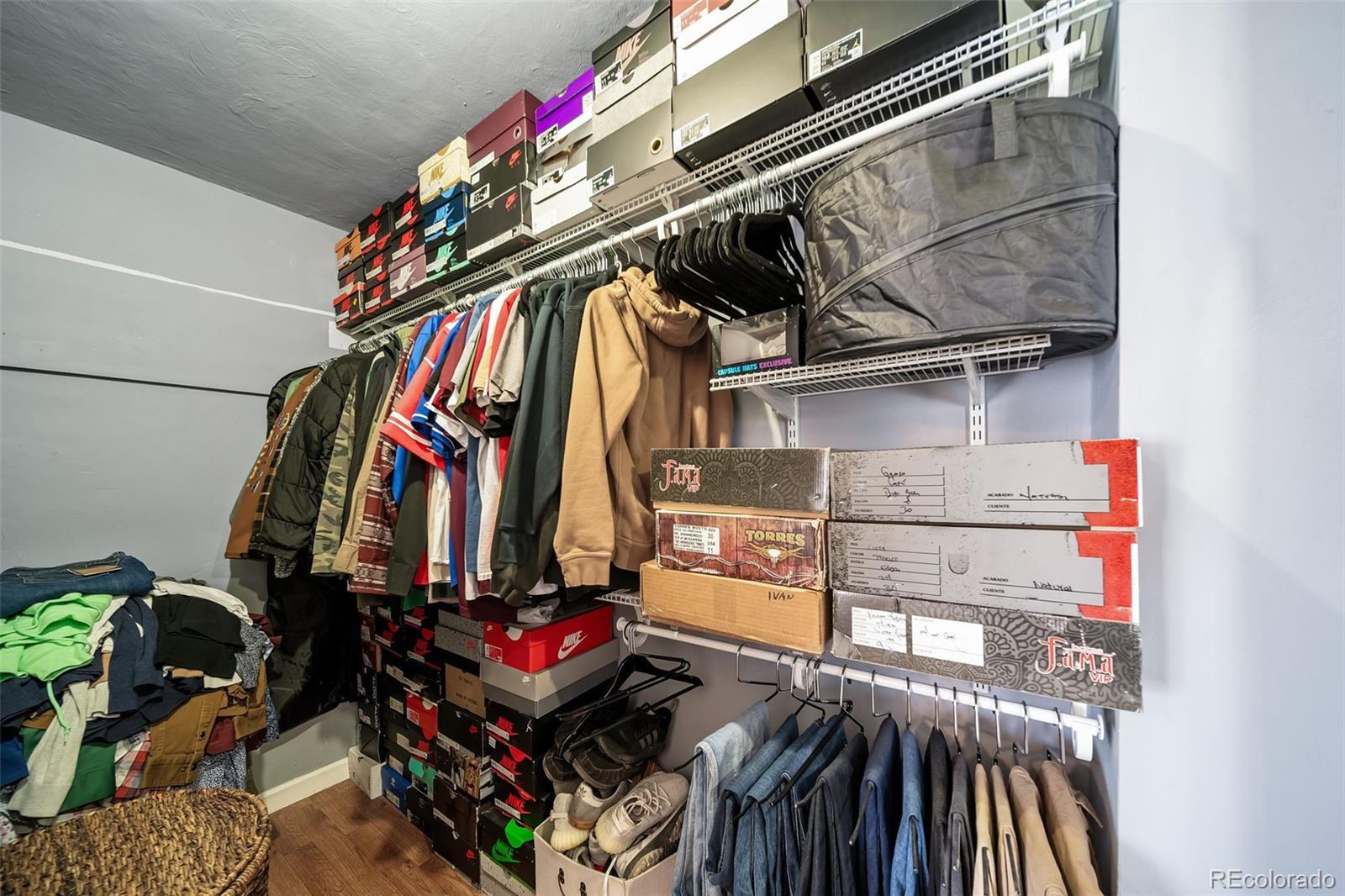 6101 South University Boulevard Centennial, CO 80121 - Photo 34 of 50 a view of walk in closet with clothes and shoes