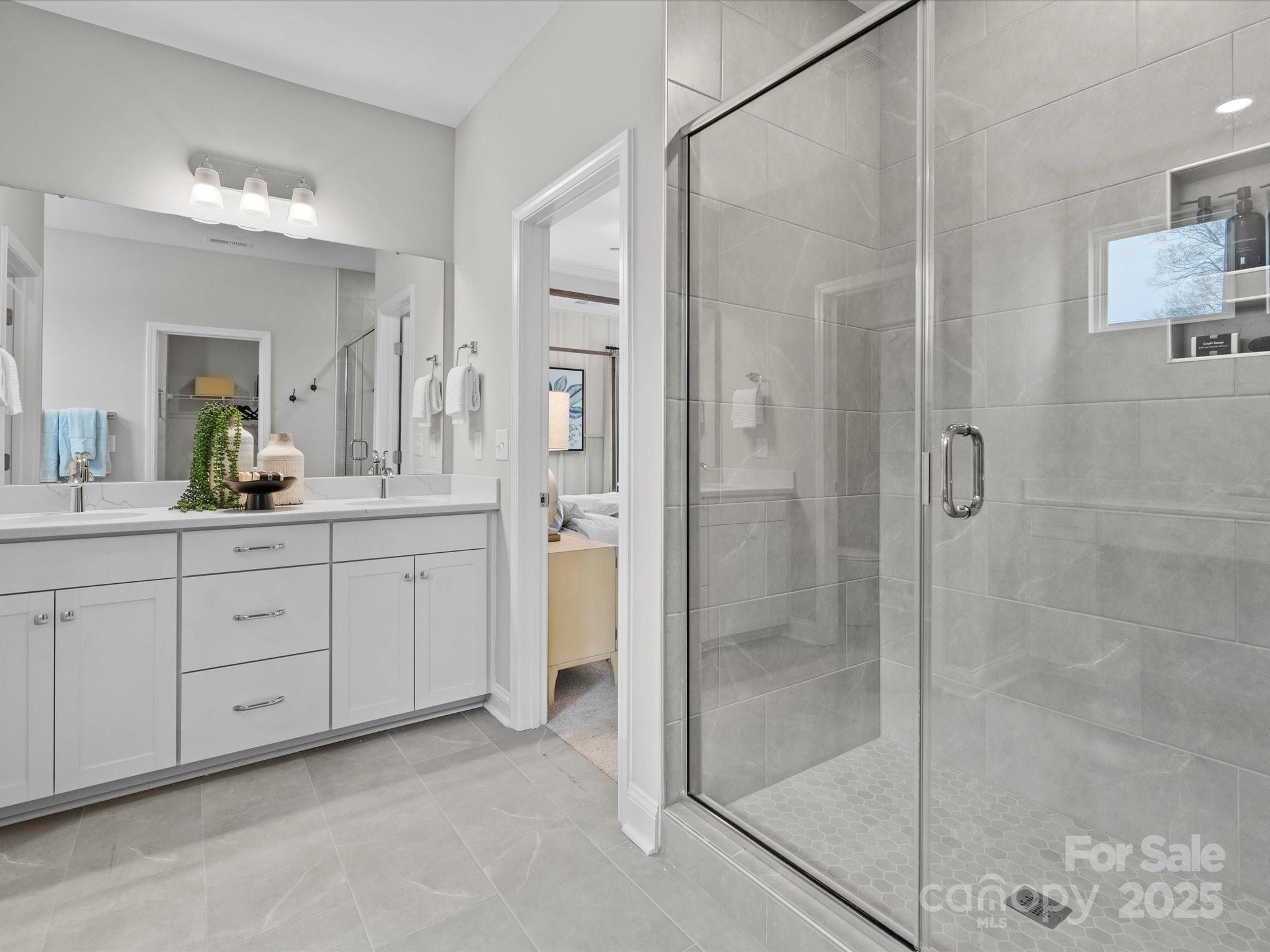 1016 Broken Spur Road Indian Trail, NC 28079 - Photo 12 of 19 a spacious bathroom with a shower sink and mirror