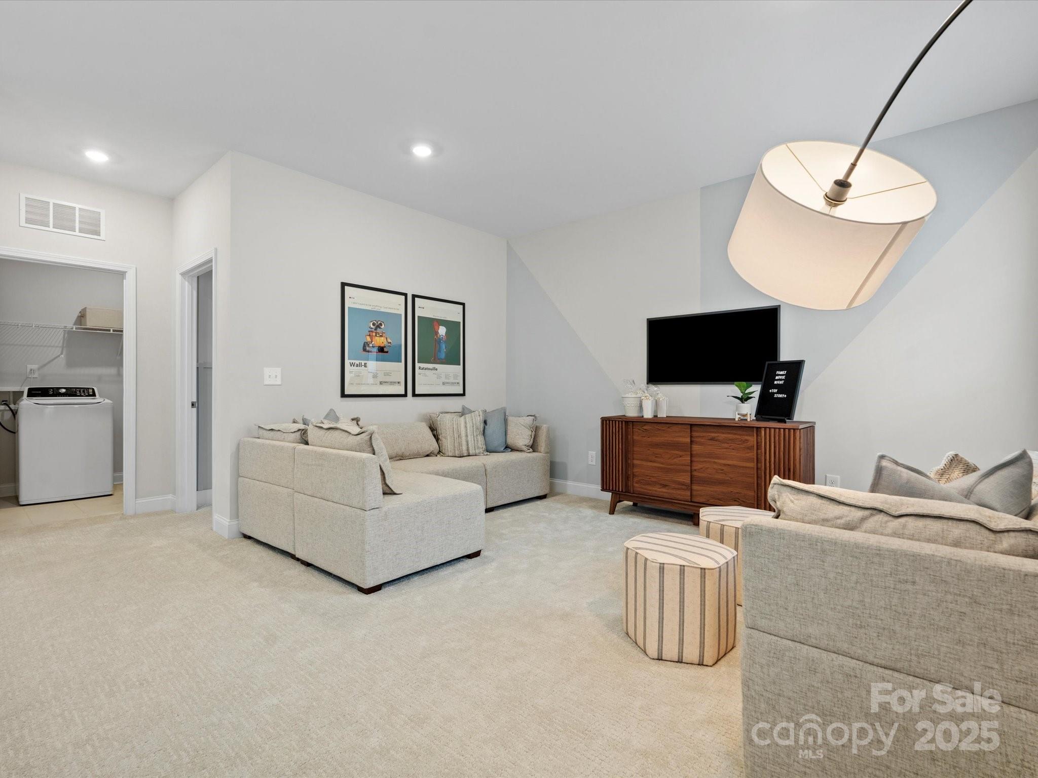 1016 Broken Spur Road Indian Trail, NC 28079 - Photo 9 of 19 a living room with furniture and a flat screen tv