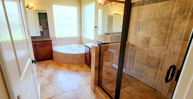 a bathroom with sink mirror and shower