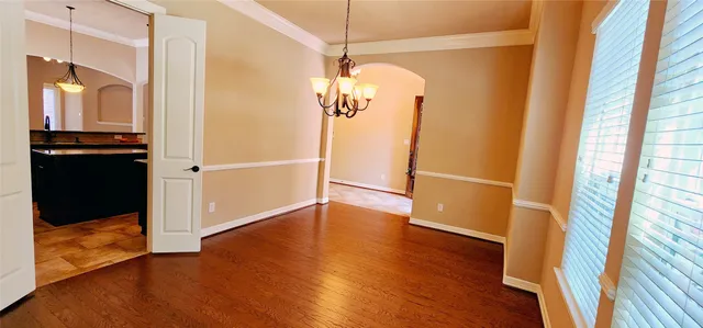 a view of a walk in closet with wooden floor