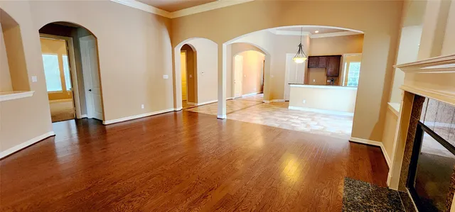 a view of empty room with wooden floor