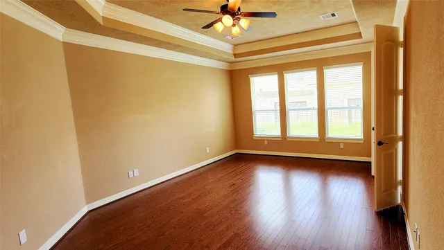a view of a room with wooden floor and a window