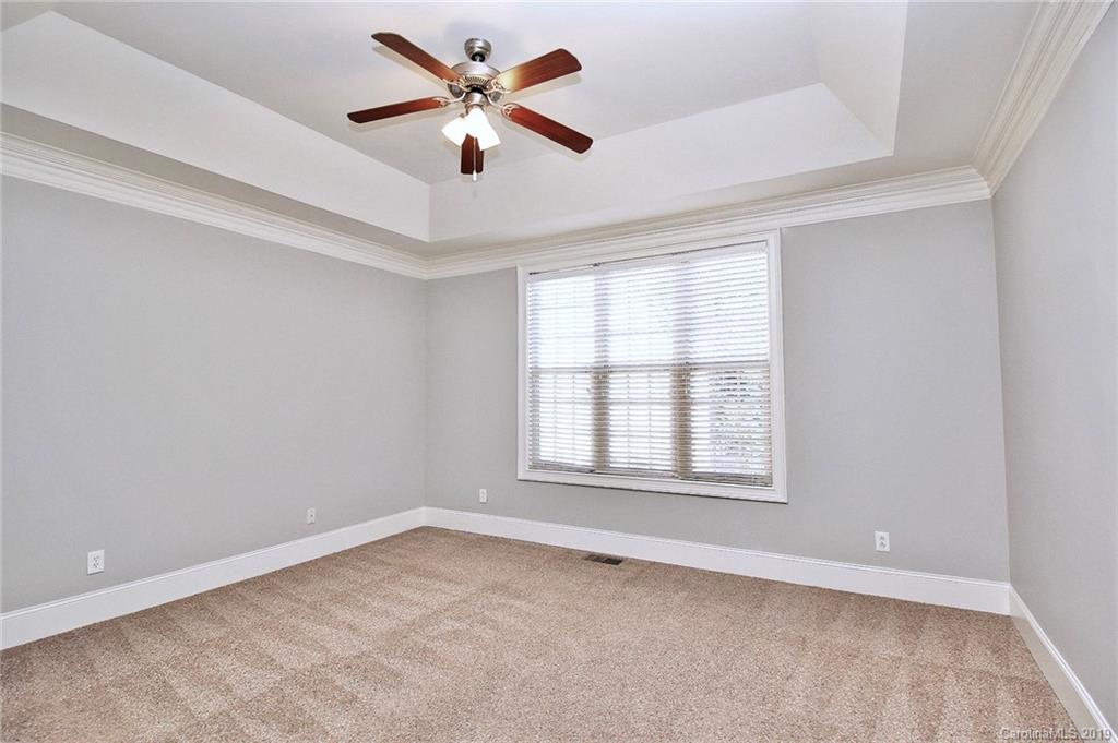 4608 McKee Road Charlotte, NC 28270 - Photo 17 of 32 an empty room with a window and a fan