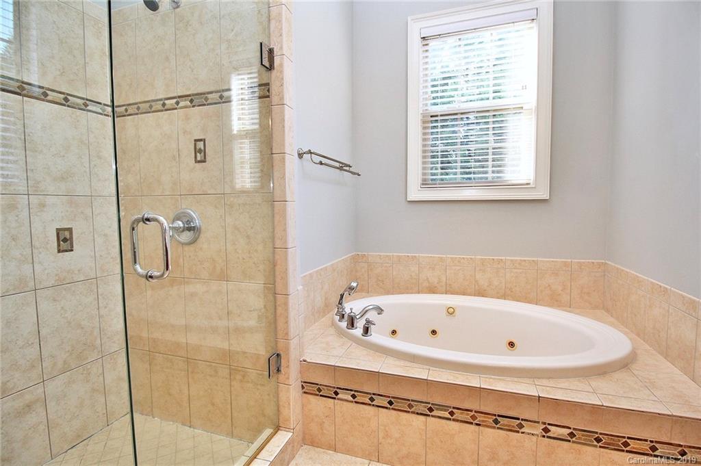 4608 McKee Road Charlotte, NC 28270 - Photo 18 of 32 a white bath tub sitting next to a window