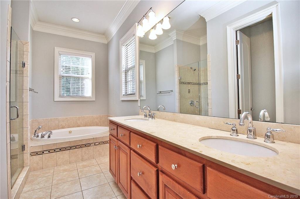 4608 McKee Road Charlotte, NC 28270 - Photo 19 of 32 a bathroom with a granite countertop sink mirror and a bathtub