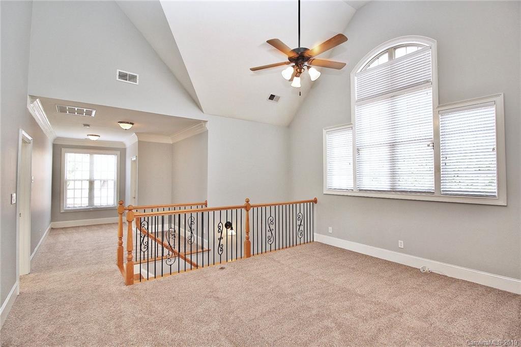 4608 McKee Road Charlotte, NC 28270 - Photo 20 of 32 an empty room with windows and fan