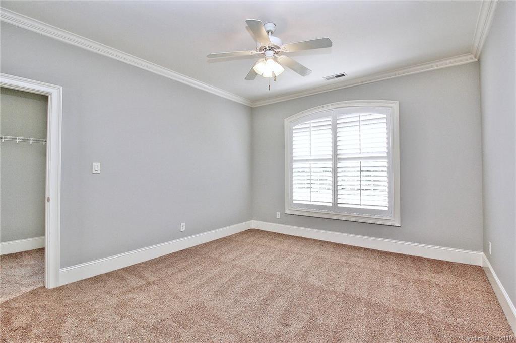 4608 McKee Road Charlotte, NC 28270 - Photo 22 of 32 an empty room with windows and ceiling fan
