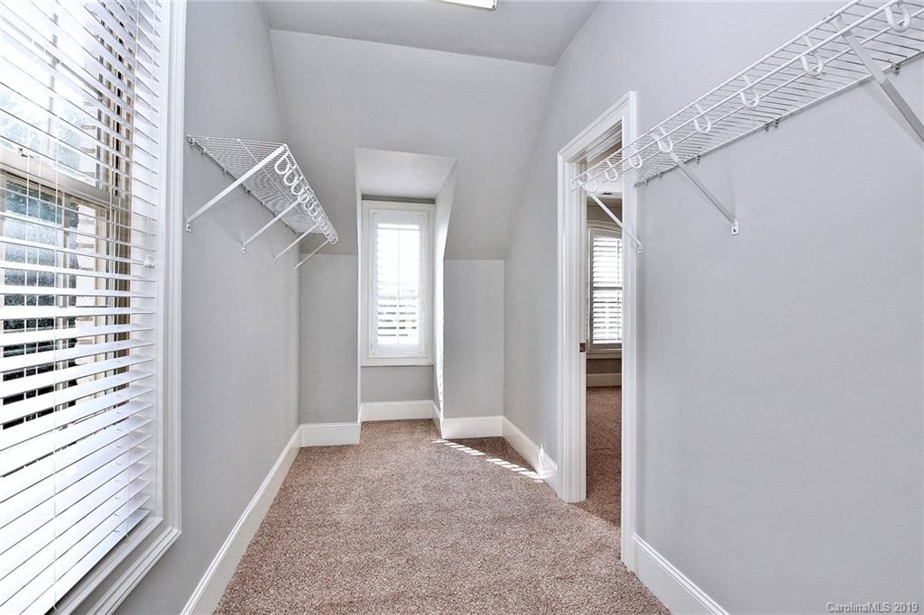 4608 McKee Road Charlotte, NC 28270 - Photo 23 of 32 a view of a hallway with a white walls and stairs
