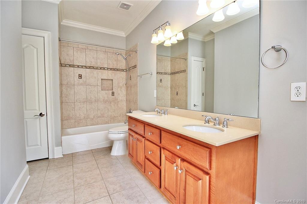 4608 McKee Road Charlotte, NC 28270 - Photo 26 of 32 a spacious bathroom with a shower sink mirror and a bathtub
