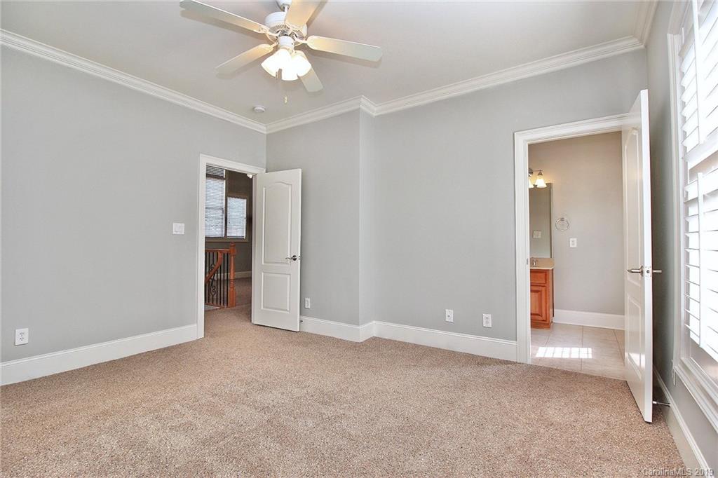 4608 McKee Road Charlotte, NC 28270 - Photo 27 of 32 an empty room with closet and a chandelier fan