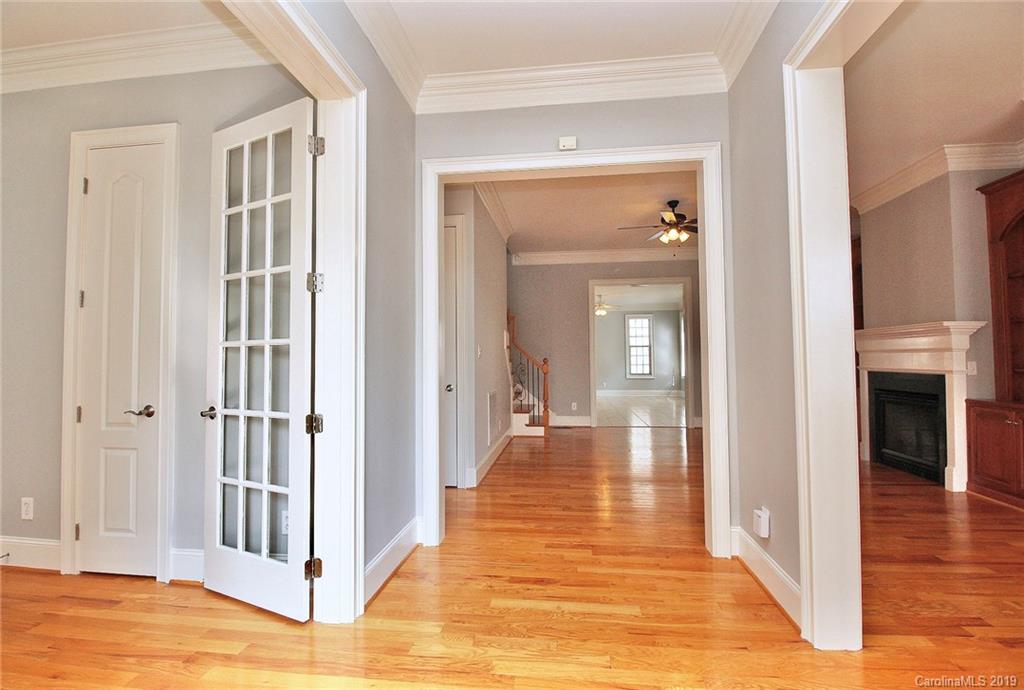 4608 McKee Road Charlotte, NC 28270 - Photo 4 of 32 a view of a hallway with wooden floor and staircase