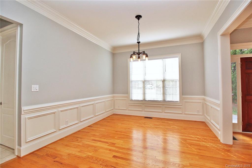 4608 McKee Road Charlotte, NC 28270 - Photo 5 of 32 a view of an empty room with a window and wooden floor
