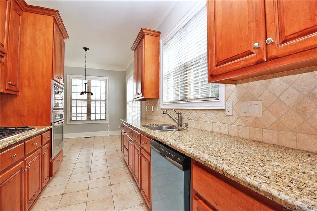 4608 McKee Road Charlotte, NC 28270 - Photo 10 of 32 a kitchen with granite countertop a sink and a window