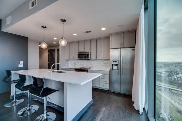a kitchen with refrigerator cabinets and wooden floor