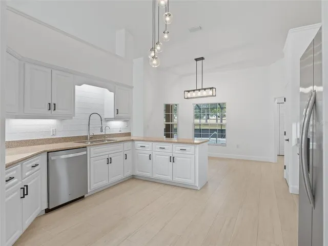 a kitchen with white cabinets and a sink