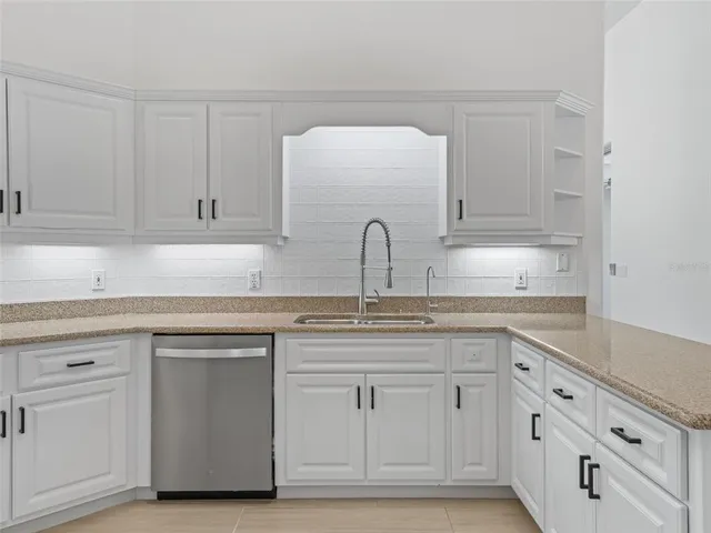 a kitchen with cabinets stainless steel appliances and a counter space