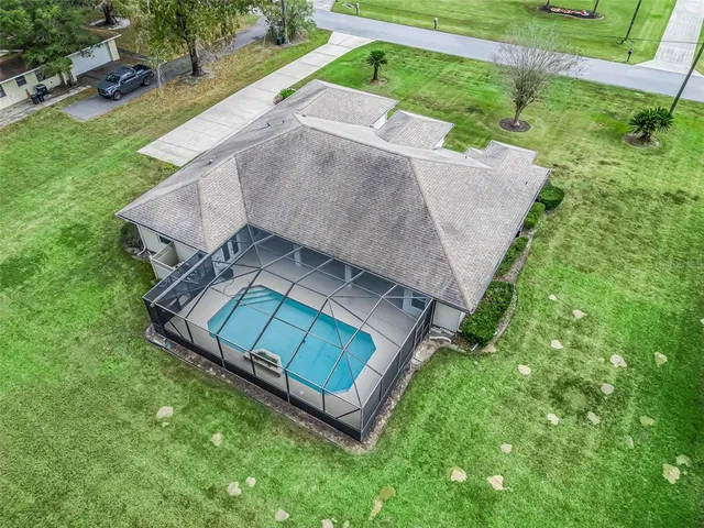 an aerial view of a house with a yard