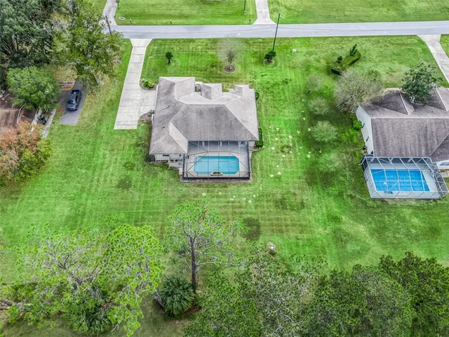 an aerial view of a residential houses with outdoor space and garden