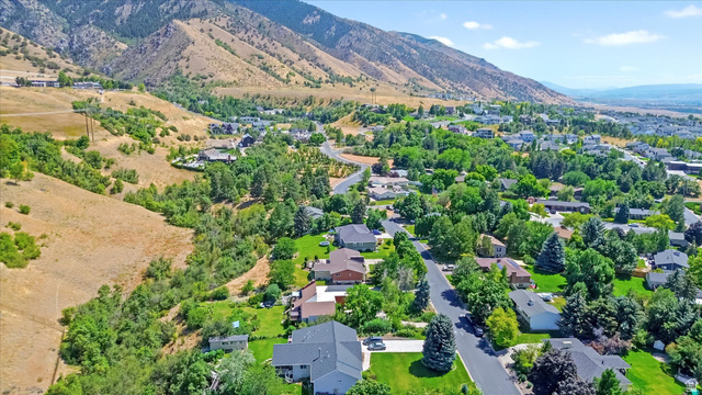 510 Spring Creek Road Providence, UT 84332 - Photo 88 of 97 Expansive aerial perspective showcasing a residential area with mature tree coverage and mountainous terrain