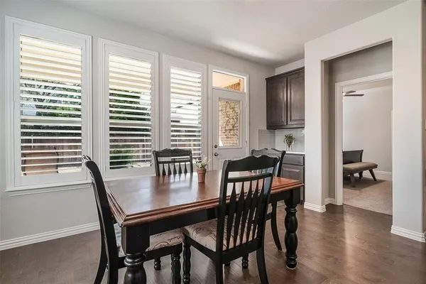 a view of a dining room with furniture and wooden floor