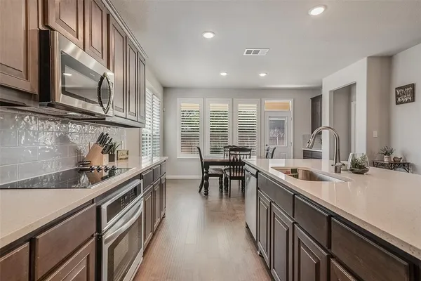a kitchen with stainless steel appliances granite countertop sink stove and cabinets