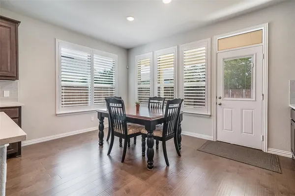 a view of a dining room with furniture and windows