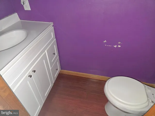 a bathroom with a sink a toilet and mirror