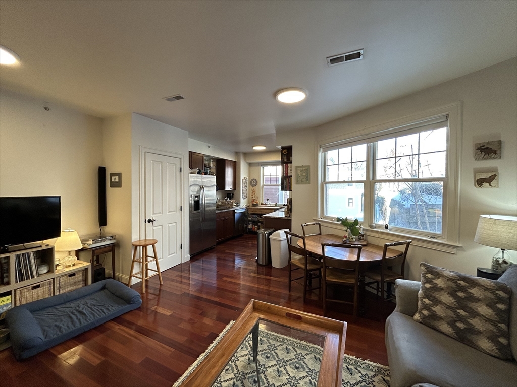 43 Pitman Street, Unit 303 Somerville, MA 02143 - Photo 2 of 12 a living room with fireplace furniture and a flat screen tv