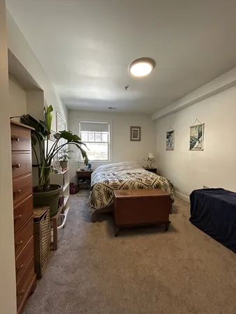 a spacious bedroom with a bed and a couch