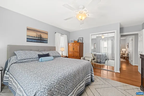 a spacious bedroom with a bed and a flat screen tv