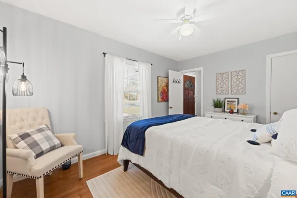 a bedroom with bed and flowerpot
