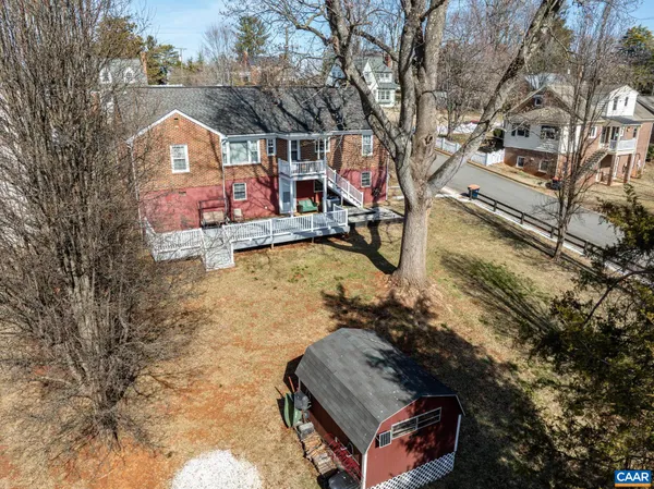 a view of a house with backyard and porch