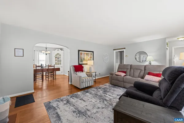a view of a dining room with furniture wooden floor and chandelier