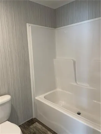 a bathroom with a shower and a toilet
