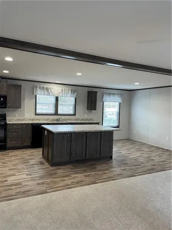 a kitchen with a stove window and cabinets