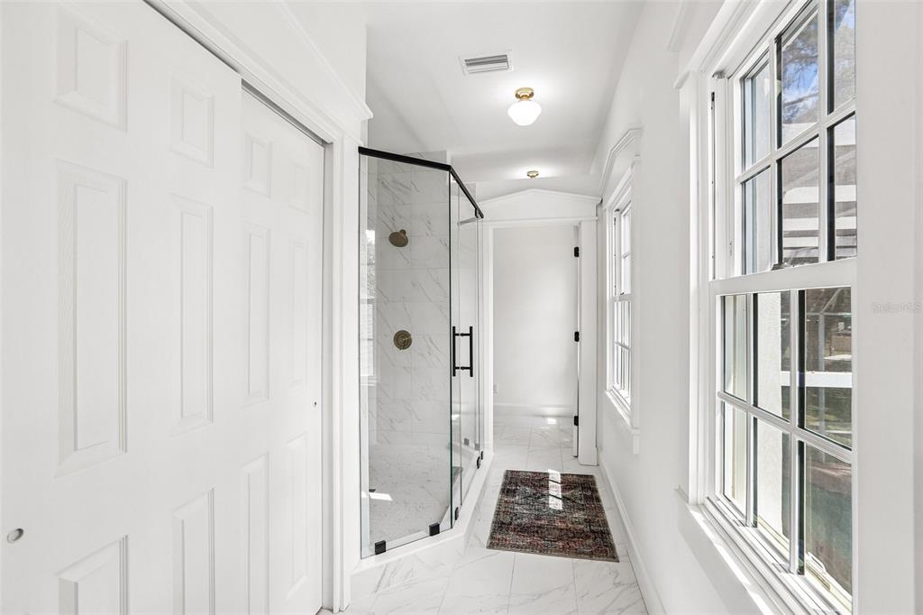 1012 Morfield Lane Brandon, FL 33511 - Photo 55 of 100 a bathroom with a glass shower door and a glass door