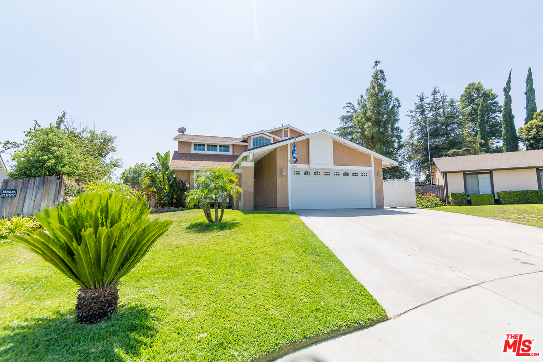 2985 North Chestnut Street Rialto, CA 92376 - Photo 1 of 30 a view of a house with a yard and a garage