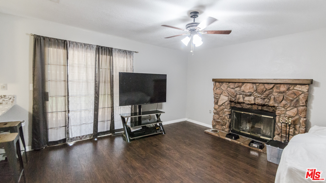 2985 North Chestnut Street Rialto, CA 92376 - Photo 14 of 30 wooden floor fireplace and windows in a room