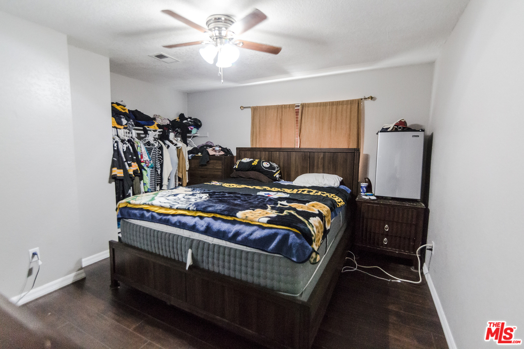 2985 North Chestnut Street Rialto, CA 92376 - Photo 18 of 30 a bed sitting in a bedroom next to a window