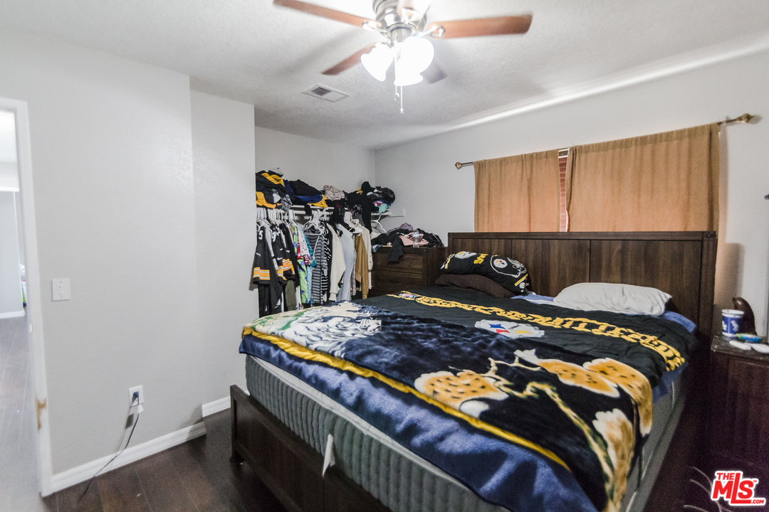 2985 North Chestnut Street Rialto, CA 92376 - Photo 19 of 30 a bed room with a bed and a window