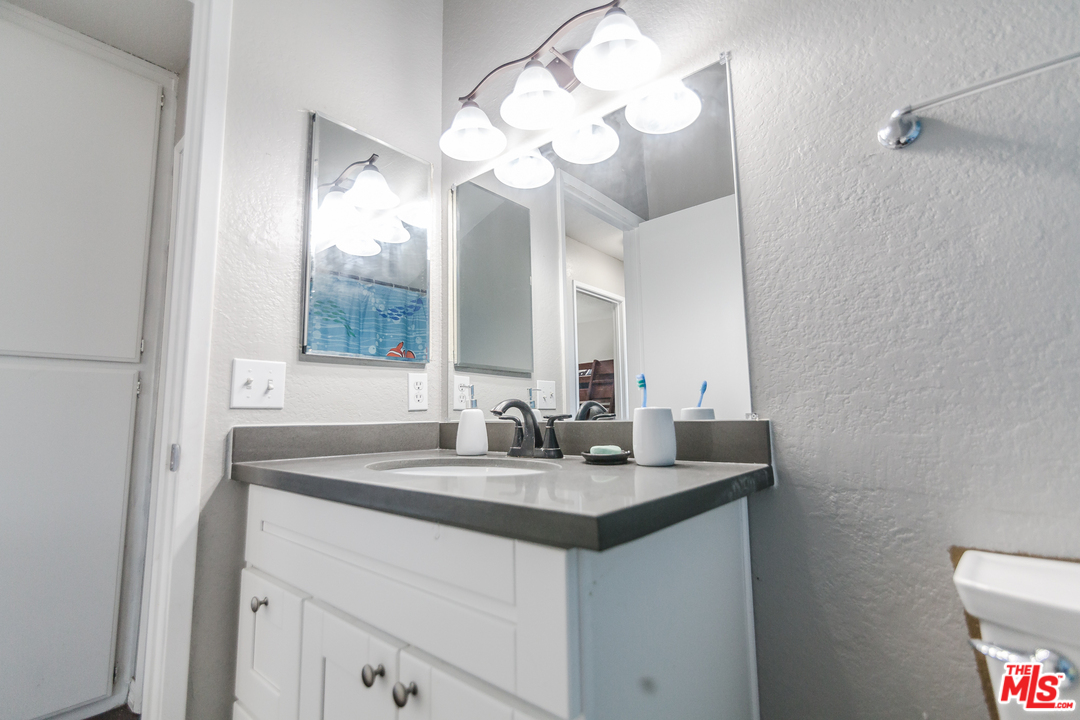 2985 North Chestnut Street Rialto, CA 92376 - Photo 21 of 30 a bathroom with a sink and a mirror