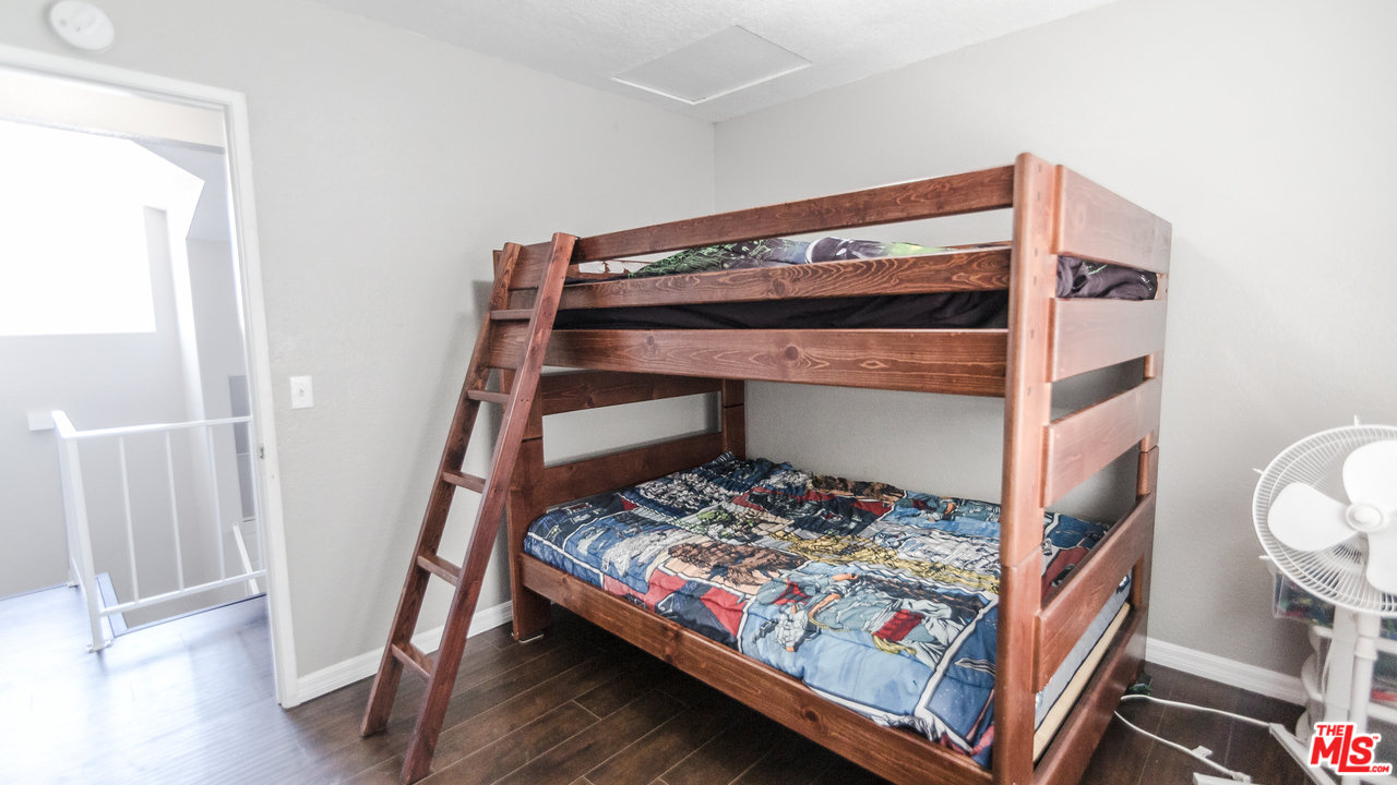 2985 North Chestnut Street Rialto, CA 92376 - Photo 23 of 30 a bedroom with a bed and a window
