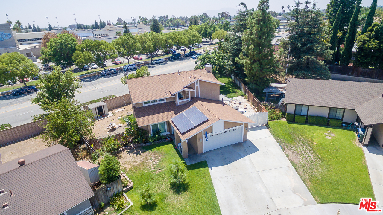 2985 North Chestnut Street Rialto, CA 92376 - Photo 26 of 30 an aerial view of a house with a garden and swimming pool