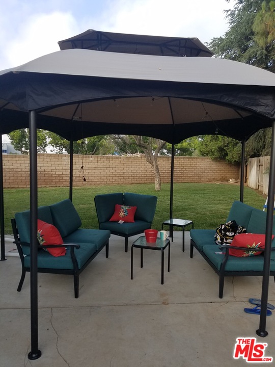 2985 North Chestnut Street Rialto, CA 92376 - Photo 30 of 30 a backyard of a house with outdoor seating
