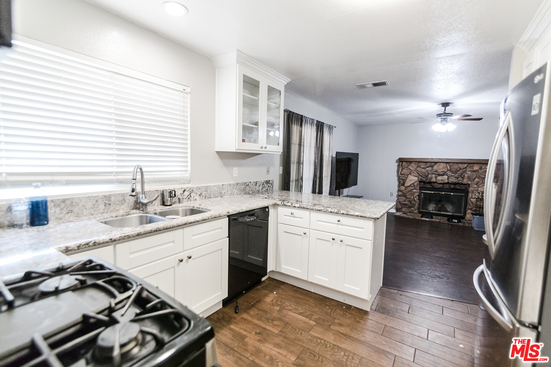 2985 North Chestnut Street Rialto, CA 92376 - Photo 10 of 30 a kitchen with a sink stove and cabinets
