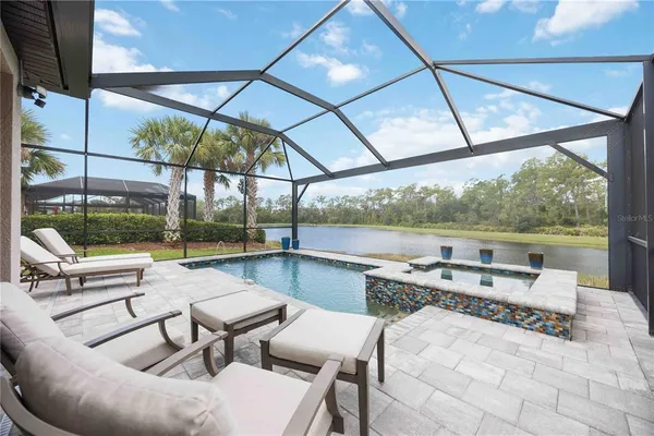 a view of a patio with a table chairs and a backyard