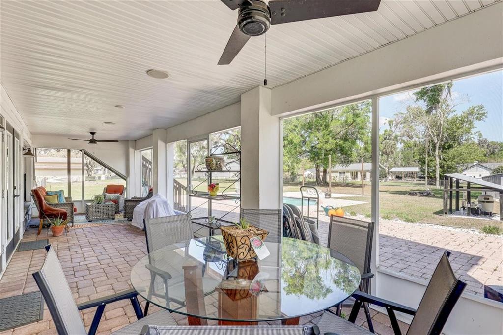 4710 Stearns Road Valrico, FL 33596 - Photo 16 of 63 a dining room with furniture a chandelier and wooden floor