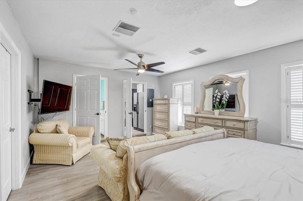 4710 Stearns Road Valrico, FL 33596 - Photo 19 of 63 a bedroom with a bed a couch and flat screen tv