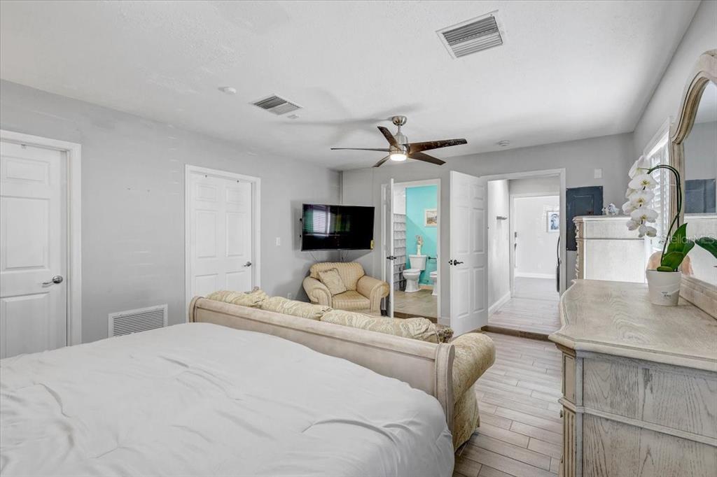 4710 Stearns Road Valrico, FL 33596 - Photo 20 of 63 a bedroom with a bed a flat screen tv and a couch